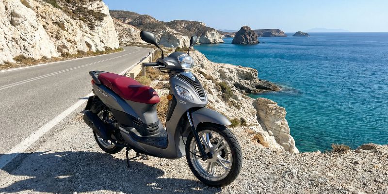 A rented scooter parked by the sea in Milos